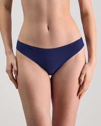 Model wears Extra-Ordinary Thong in Medieval Blue. On body front view