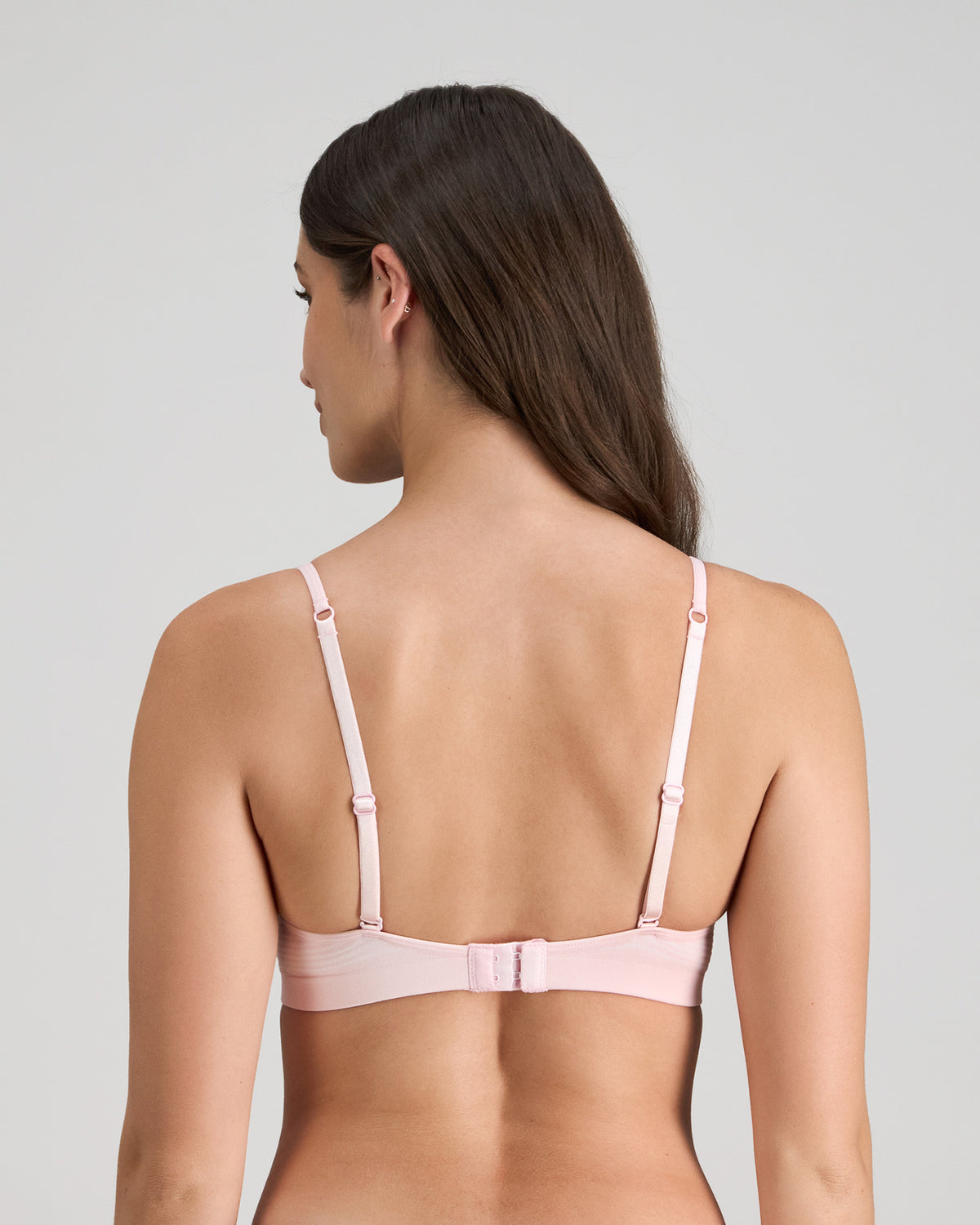 Model wears Simply Seamless Wire Free Bra in ICY PINK/WHITE STRIPE. On body back view