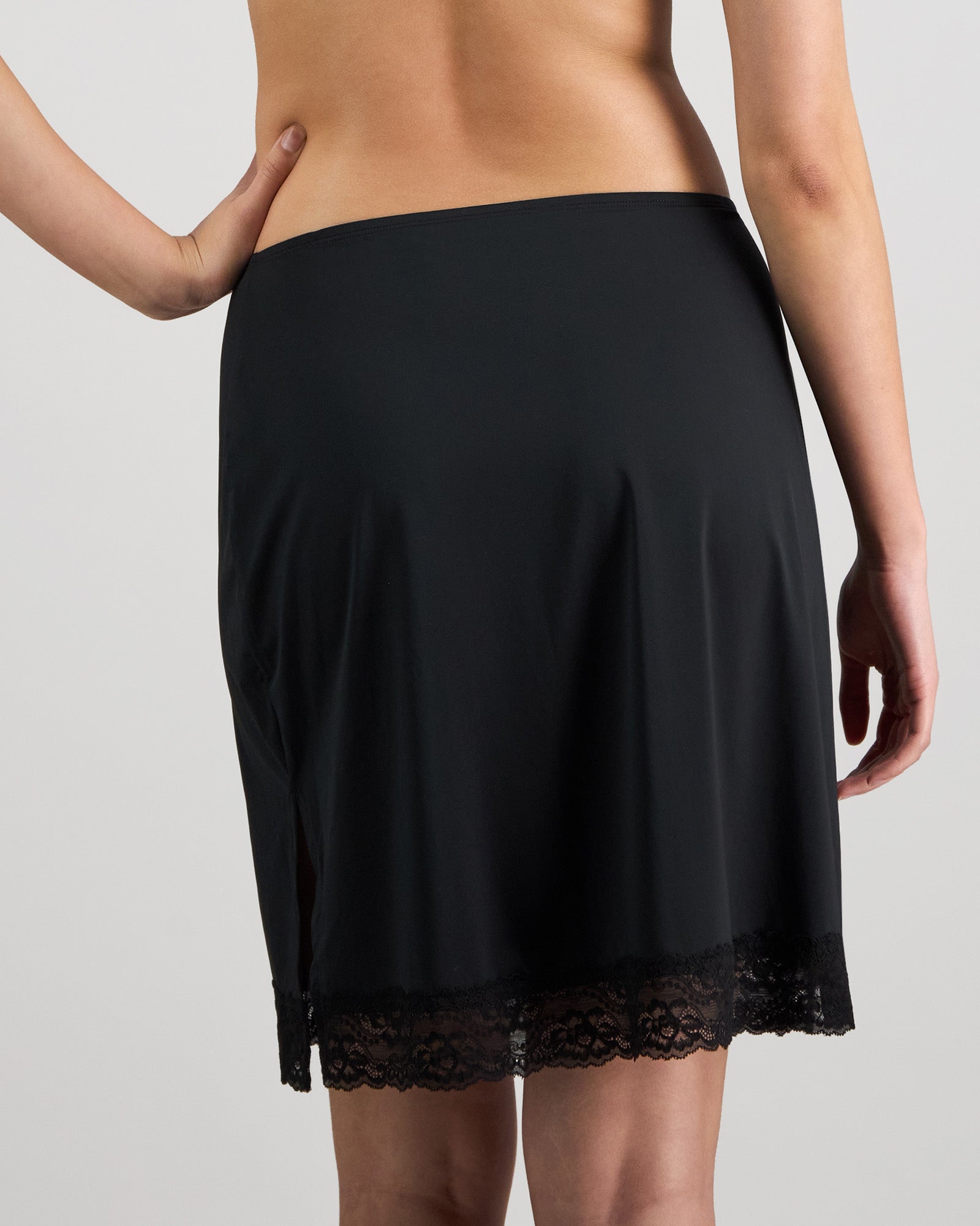 Model wears Understatement Slip in BLACK. On body back view