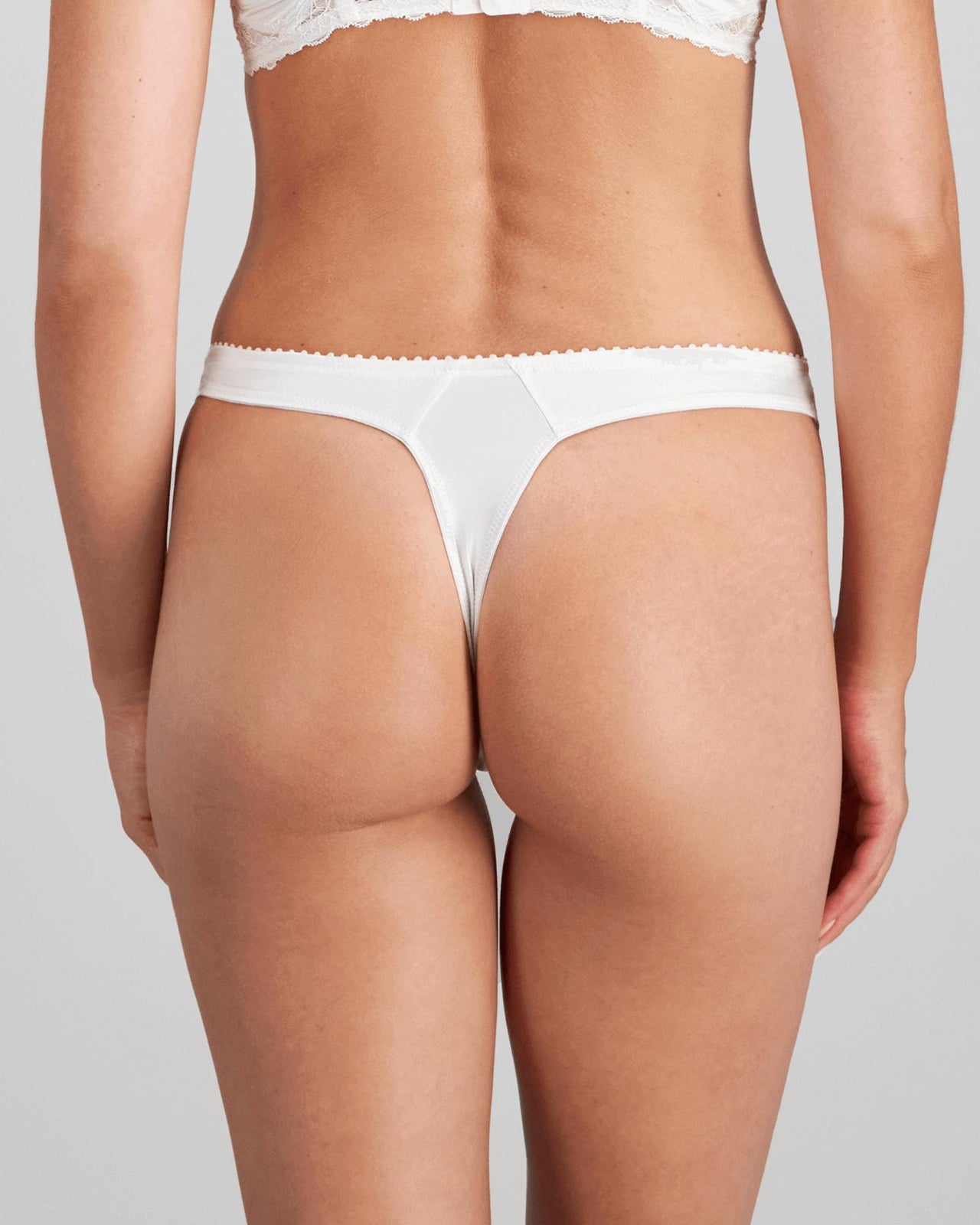Model wears Shivani Thong in SUGAR. On body back view