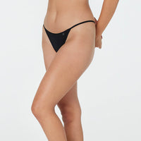 Model wears Clemence Thong in BLACK. On body side view