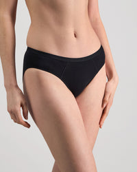 Model wears Body Cotton Bikini in BLACK. On body side view