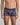 Model wears Retros Print Mens Trunk in GOLD TROPICAL PRINT. On body front view