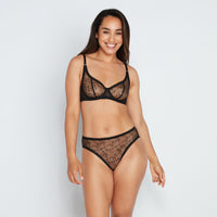 Model wears Freedom To Move High Cut Brief in BLACK. On body front view
