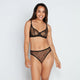Model wears Freedom To Move High Cut Brief in BLACK. On body front view