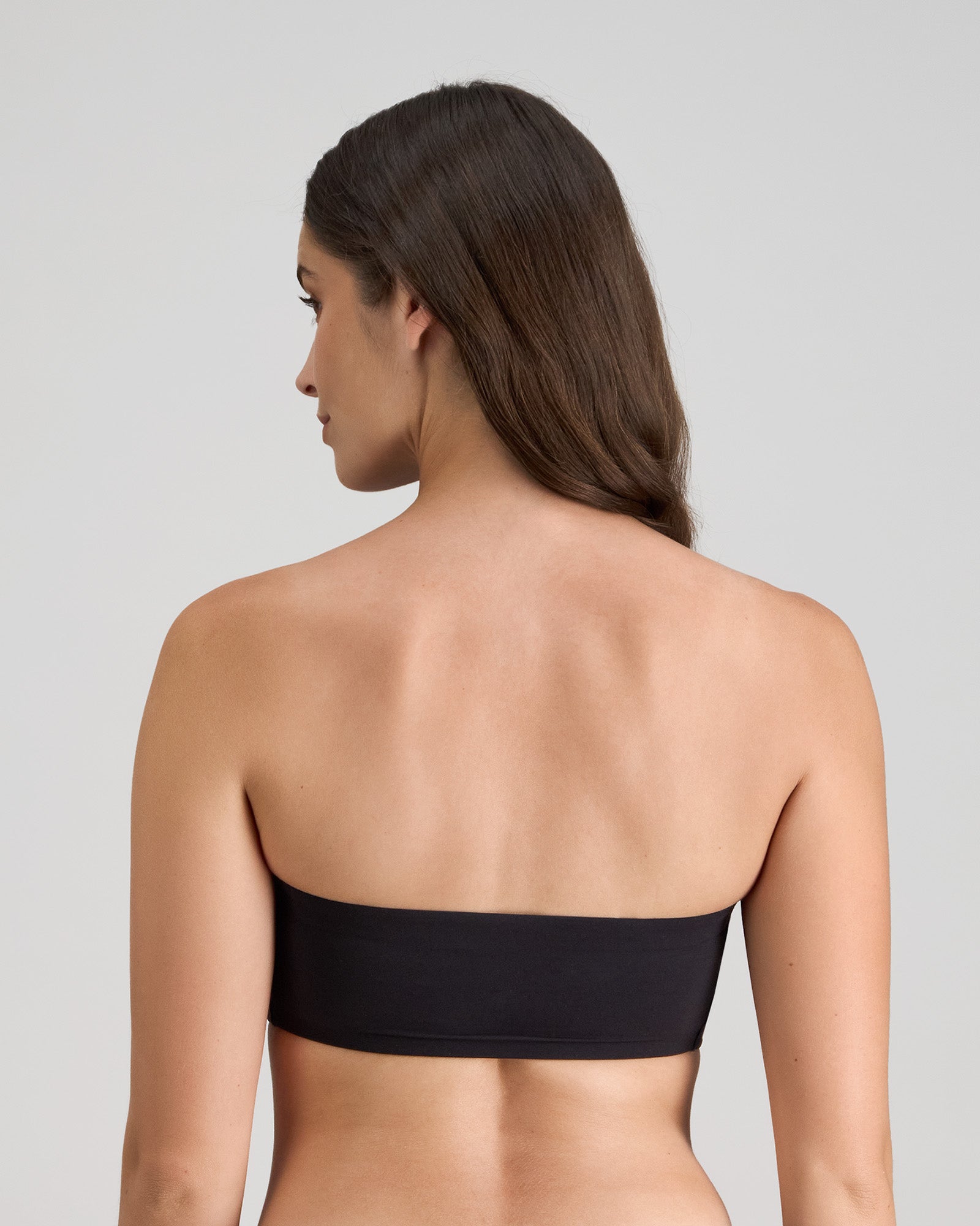 Model wears Extra-Ordinary Bandeau in BLACK. On body back view