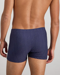 Model wears Cotton Stretch Mens Trunk in PEACOAT PINSTRIPE. On body back view