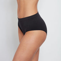 Model wears Seamless Full Brief in BLACK. On body side view