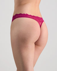 Model wears All Lacey Thong in FANTASY FUCHSIA. On body back view