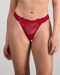 Model wears My Fit Lace Thong in JESTER RED. On body front view