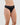 Model wears Cotton And Lace Thong in BLACK. On body side view