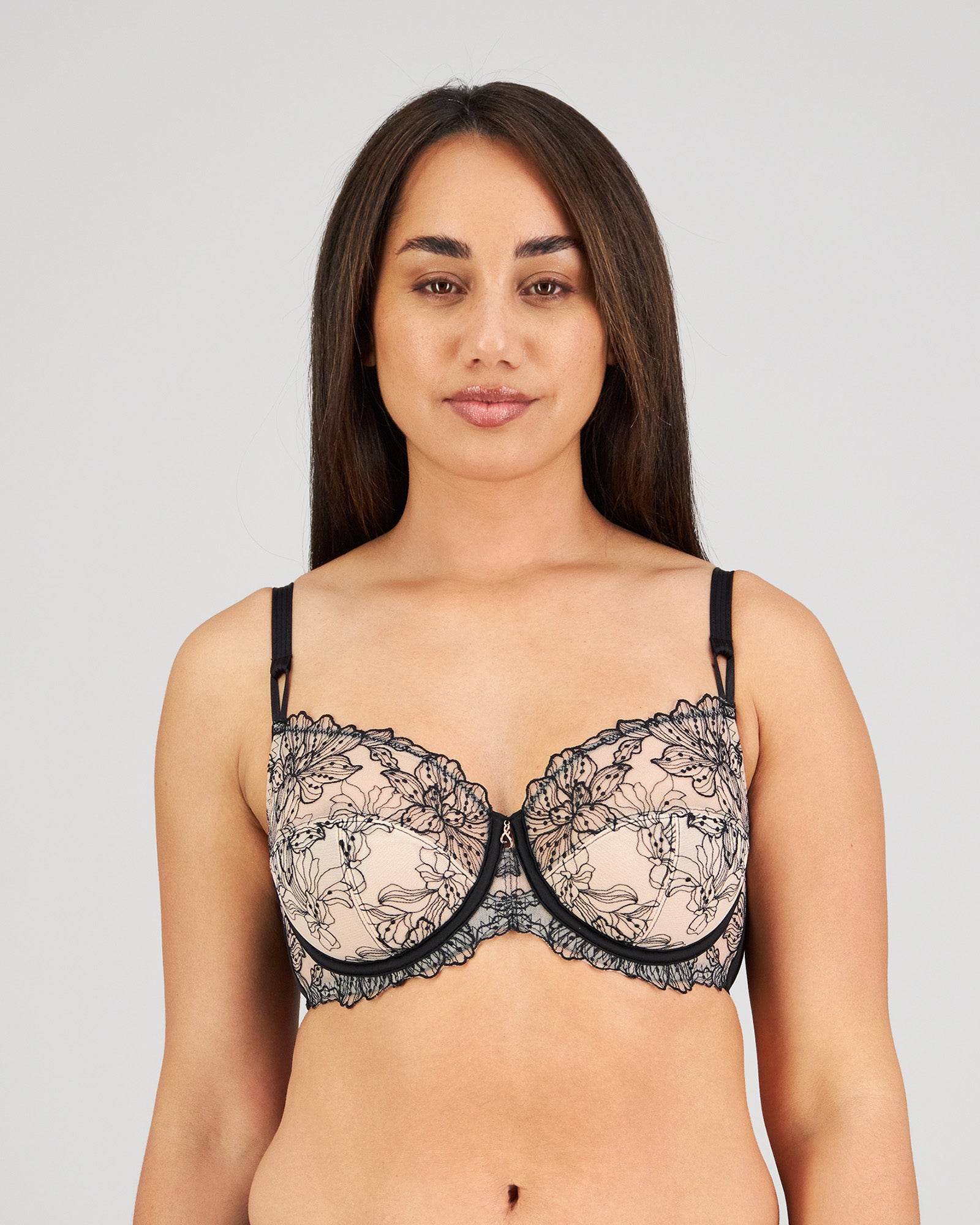 Model wears Magnetism Underwire Bra in BLACK/LATTE. On body front view