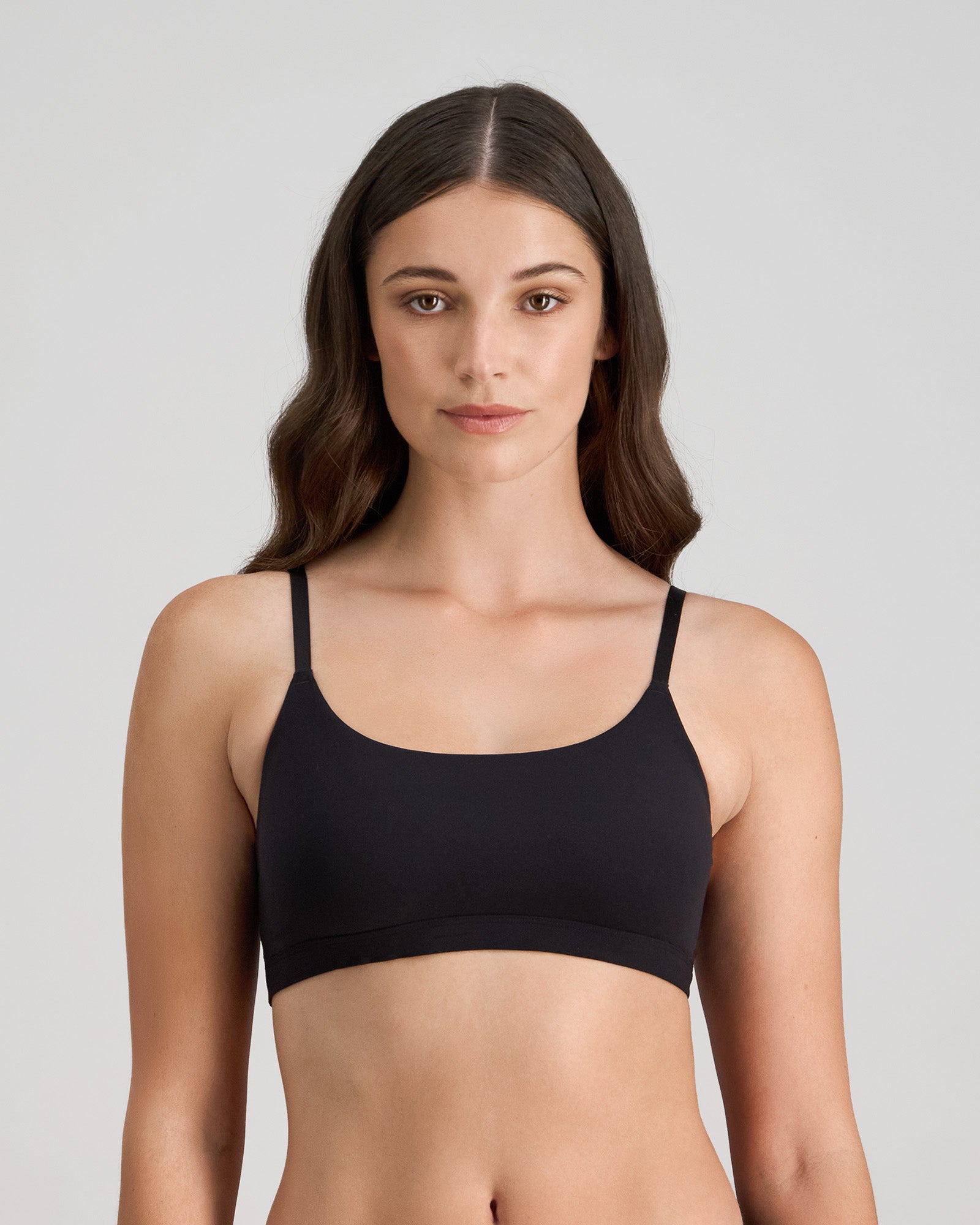 Model wears Extra-Ordinary Crop Top in BLACK. On body front view