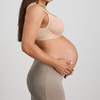 Hero banner Pregnant woman wearing a beige maternity bra and leggings against a light gray background