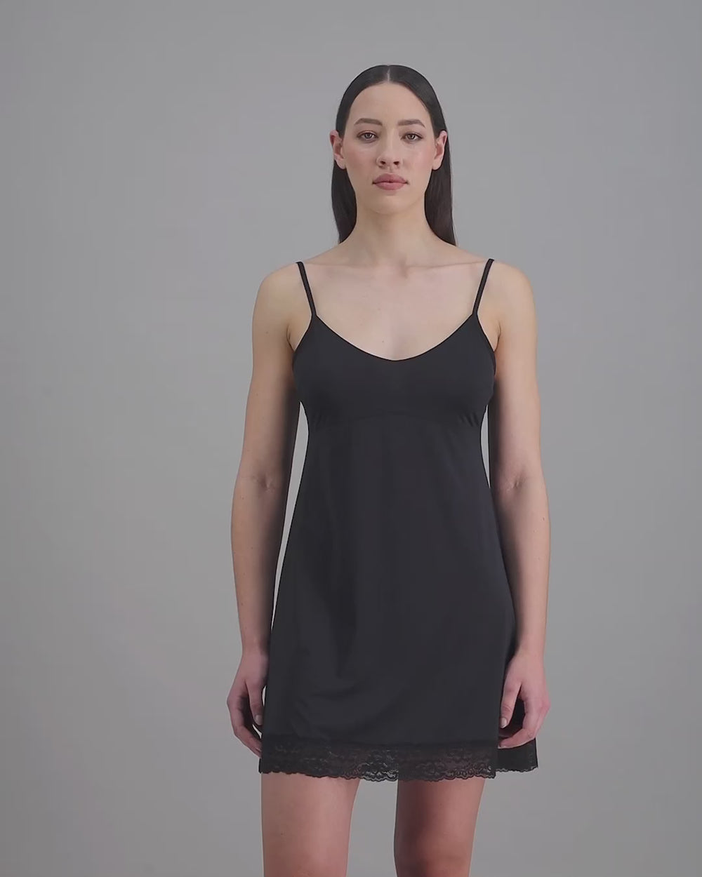model-poses-in-black-slip-dress