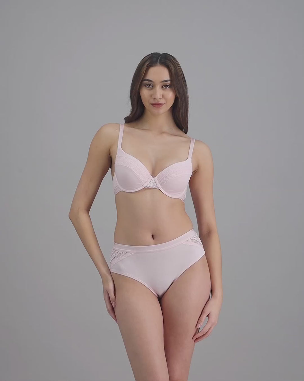 model-poses-in-pale-pink-lingerie-set
